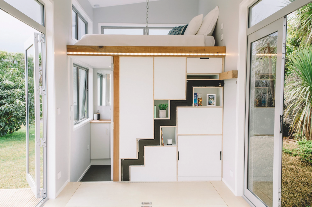 The bathroom and bedroom loft space in the millennial. Photo Credit: Build Tiny