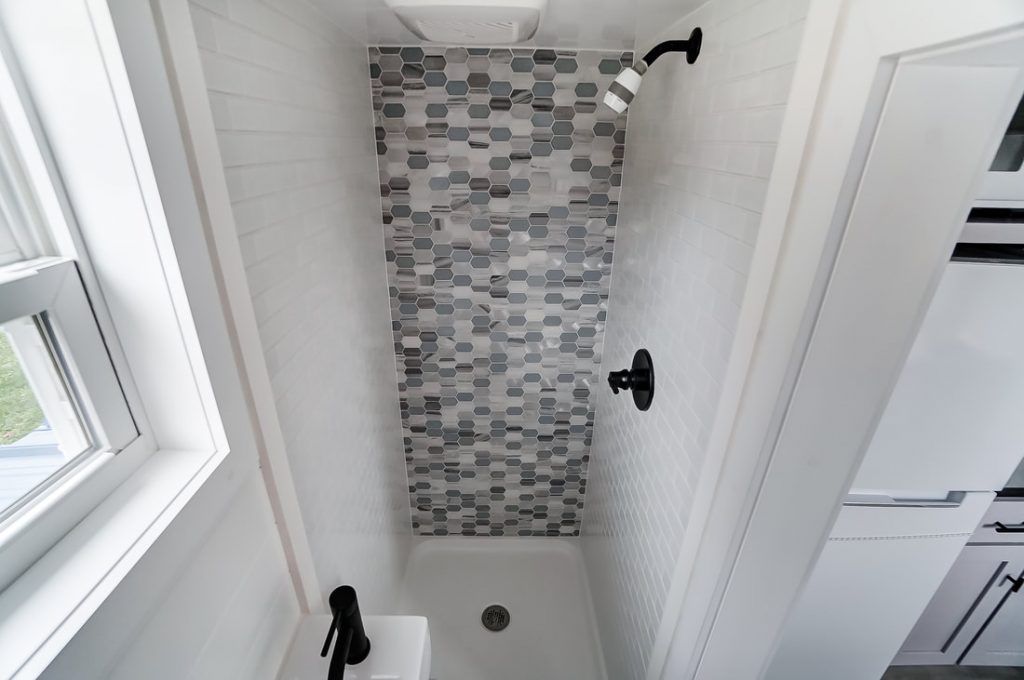 This shower by Modern Tiny Living showcases a beautiful monochrome mosaic. 