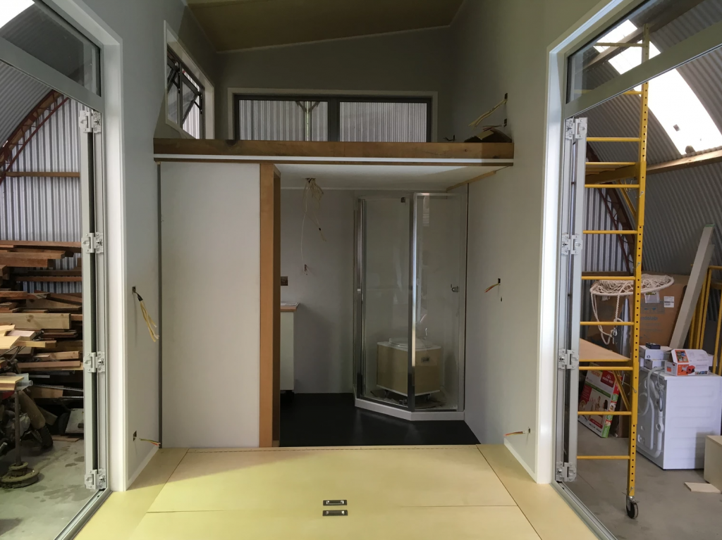 The bathroom and bedroom loft space during the build. Photo Credit: Build Tiny