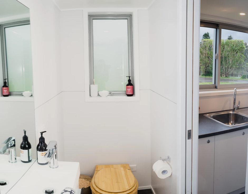 The entire tiny house bathroom dimensions are minimal in this tiny house. The sink, toilet and shower are fit into the bathroom at the end of the house.