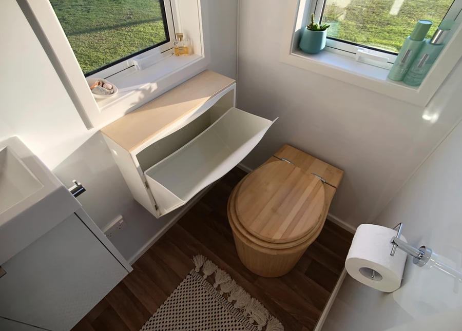 This bambooloo composting toilet in the Bister tiny house fits nicely into the bathroom. The tiny house toilet dimensions are relatively small.