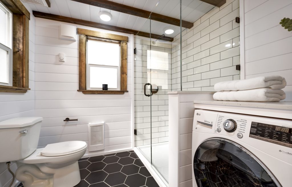 The toilet in the Loft tiny house. This flush toilet uses traditional tiny house toilet plumbing.