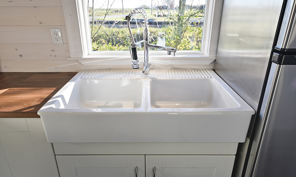 This is a farmhouse kitchen sink with two basins in the Loft tiny house.