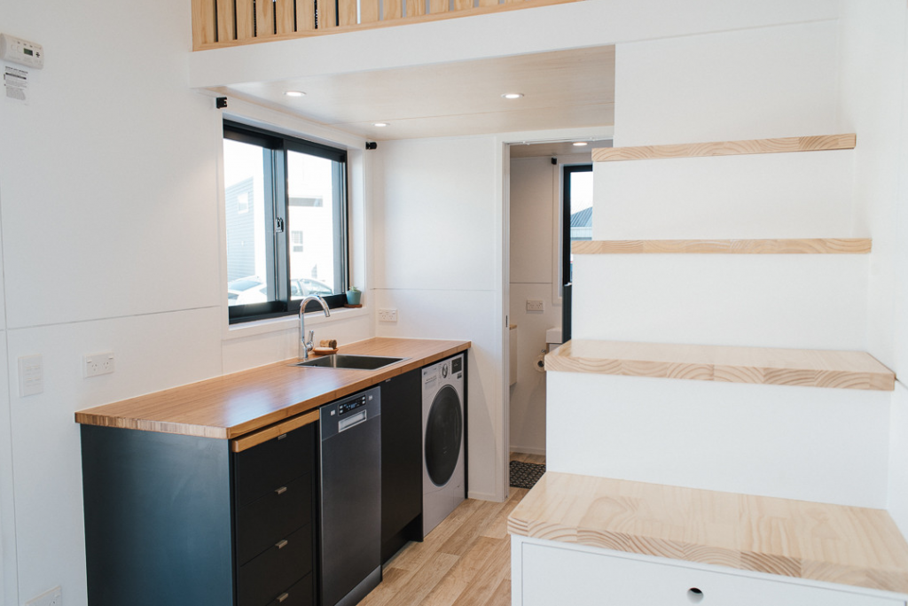 A matte black tiny house dishwasher in the Ibot tiny house kitchen.