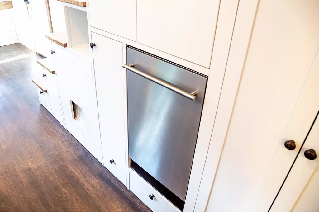 An in-built dishwasher in the Farmhouse by Liberation tiny homes.