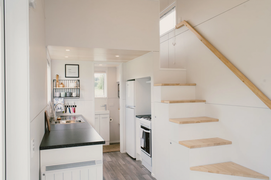 the kitchen and staircase of the archer tiny house by Build Tiny