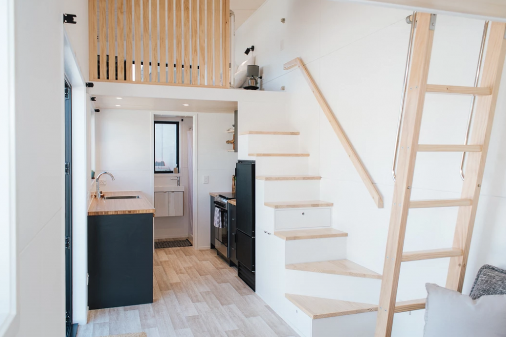 As you step into the tiny house, the kitchen and bathroom are on the left.