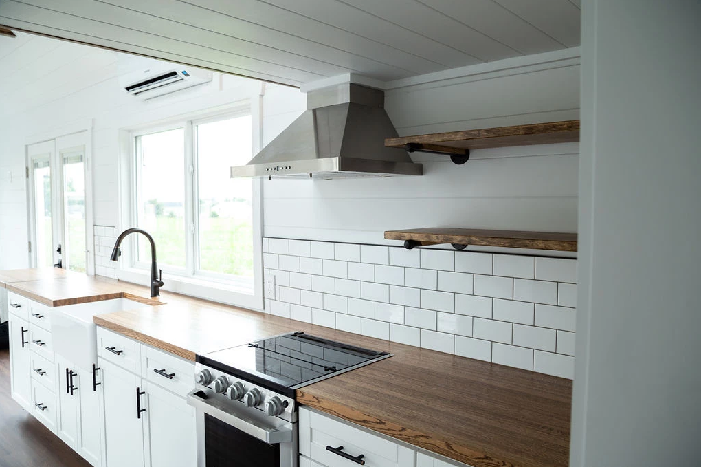 Using a hood vent in your kitchen can help with venting, rather than just relying on in-build tiny house roof ventilation