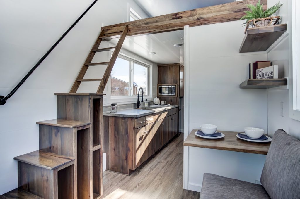 The Cocoa tiny house by Modern Tiny Living has a tiny house loft over kitchen area.