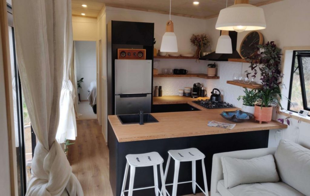 The Tiny One house has a U-shaped kitchen with additional storage.