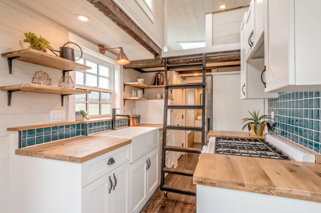 The Westcoast tiny house has a ladder on a wheels that can slide away when not in use