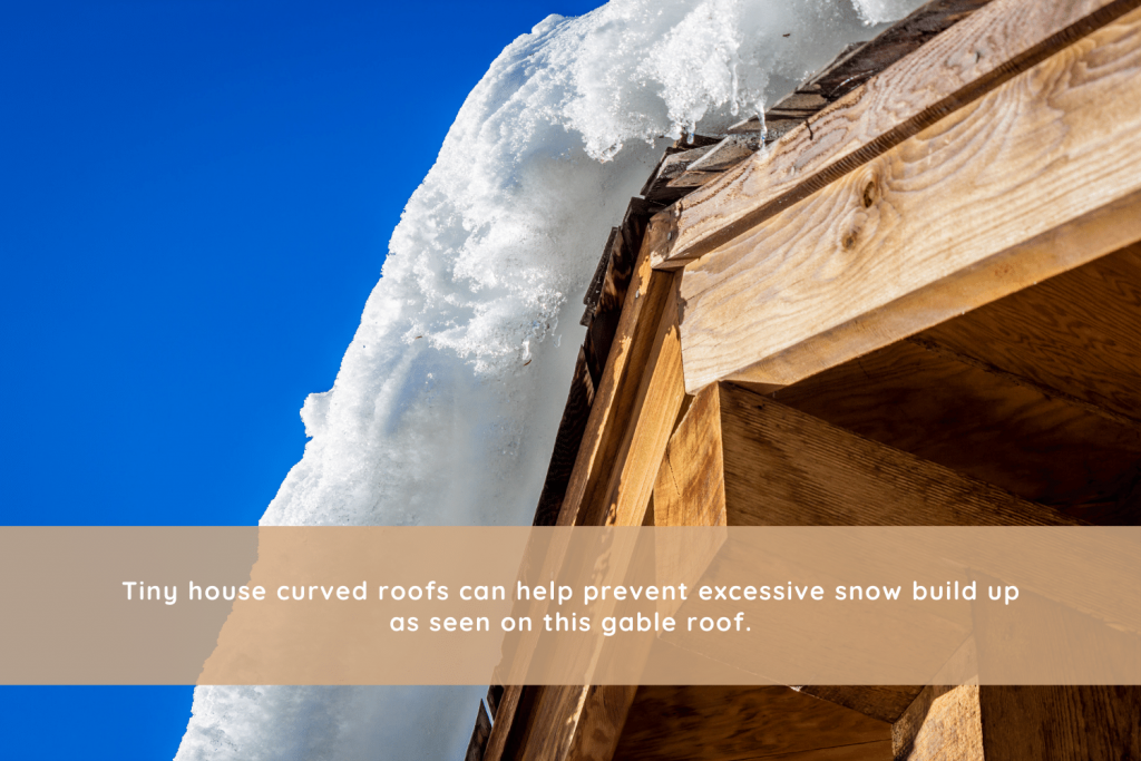 Tiny house curved roofs can help prevent excessive snow build up as seen on this gable roof.