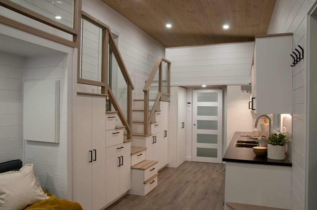 The dual staircase with lots of storage options in the Charme tiny house by Minimaliste Homes
