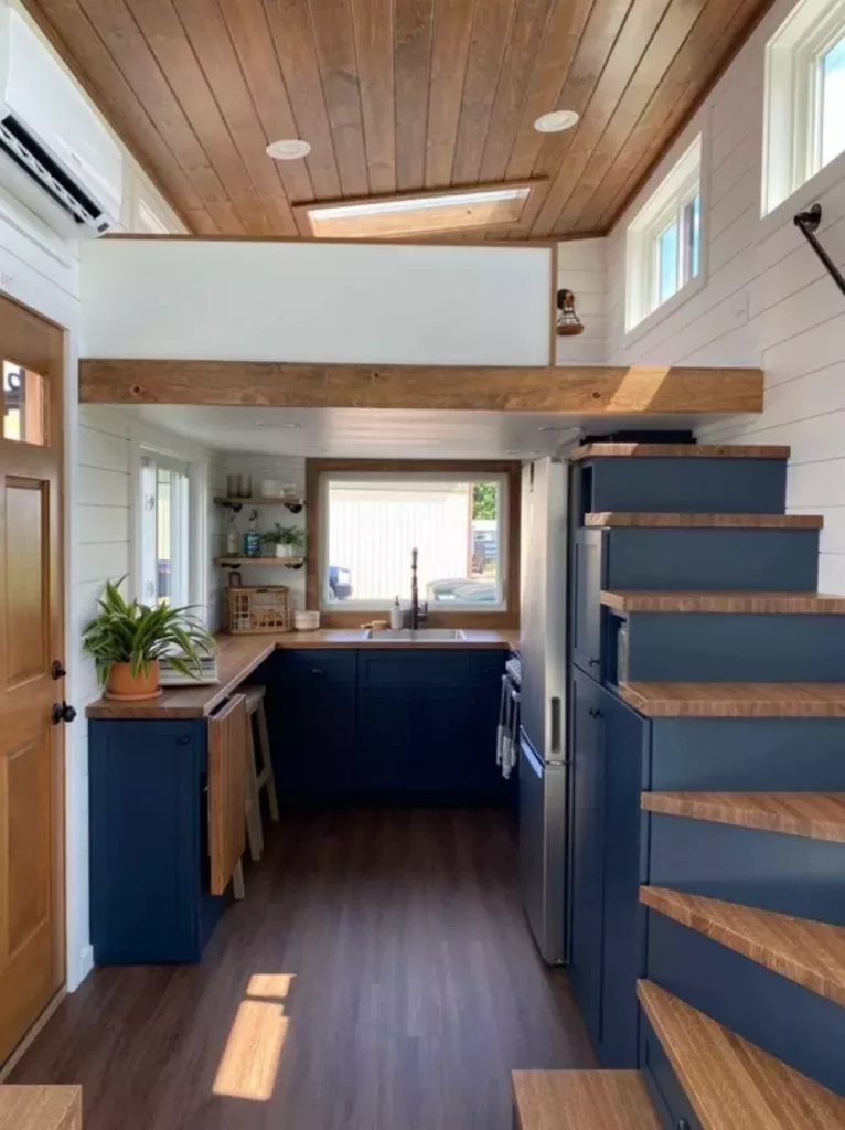 Lancaster tiny house interior with matte blue and rich wood colors