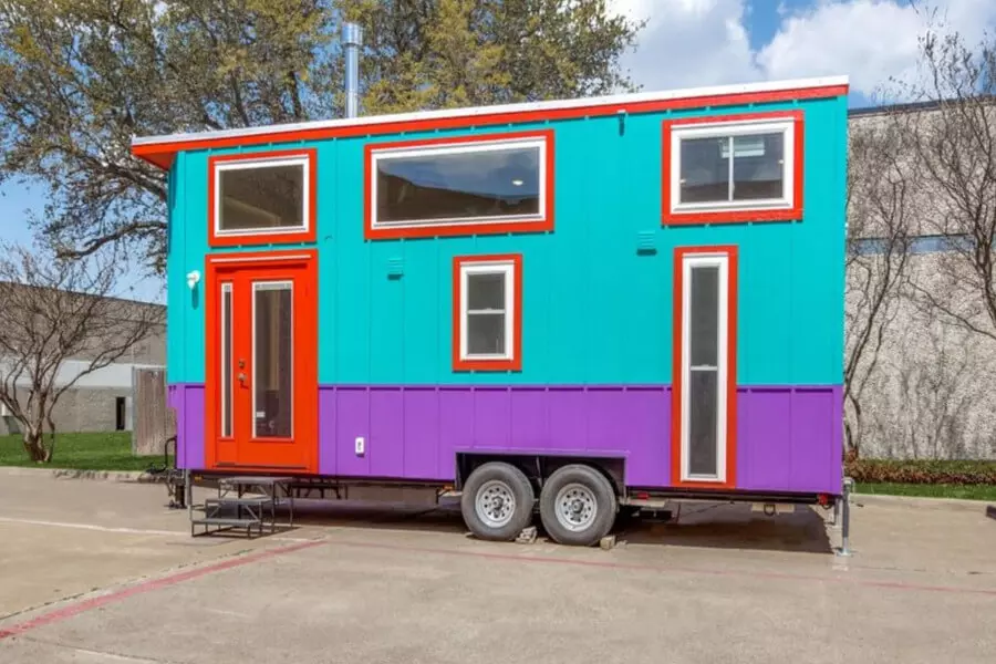 Casita chilome tiny house exterior has red, turquoise, white and purple colors.