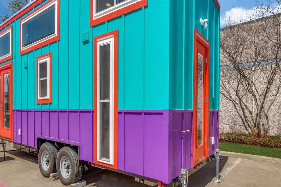 Tiny house paint colors on the side of the Casita chilome are turquoise, red and purple.